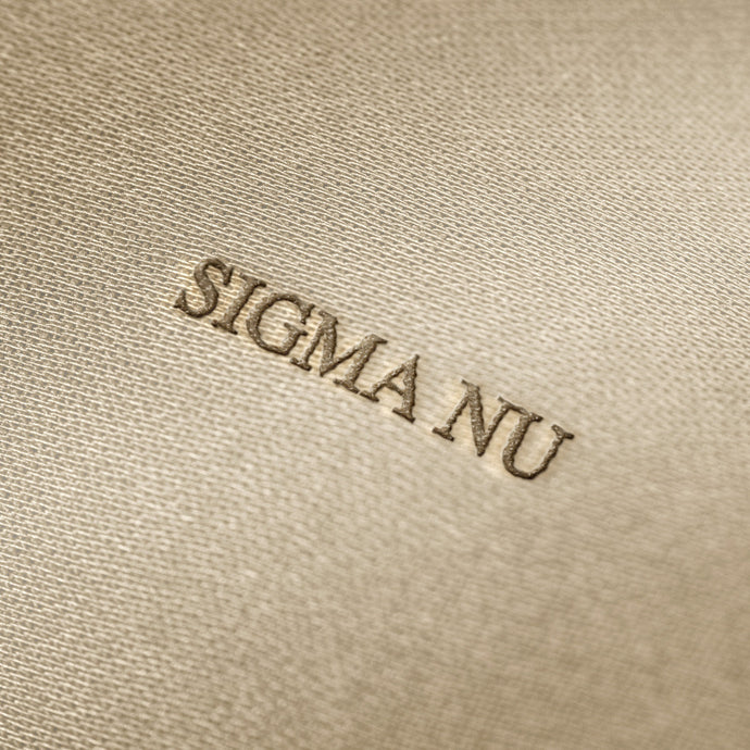 Soft beige fabric close-up showing a smooth, heavyweight knit texture with gentle folds and subtle draping.