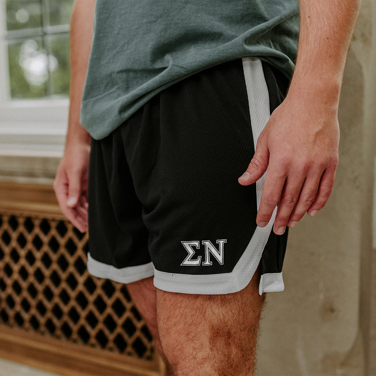 Sigma Nu Greek Fraternity Black 7" Mesh Shorts with Greek letters.