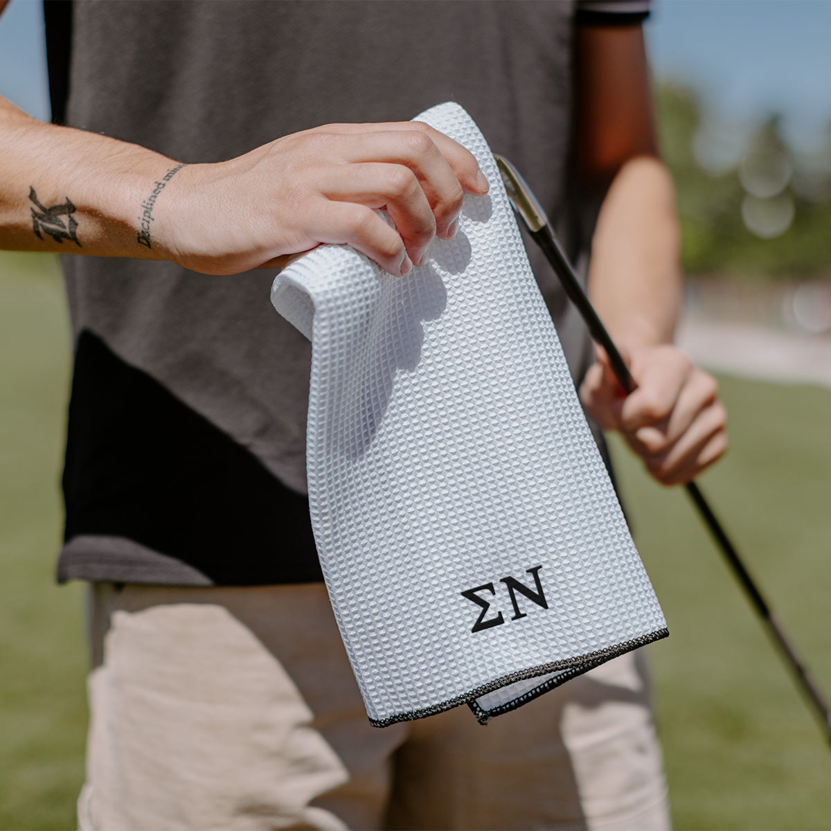 Sigma Nu golf towel embroidered with Greek letters.