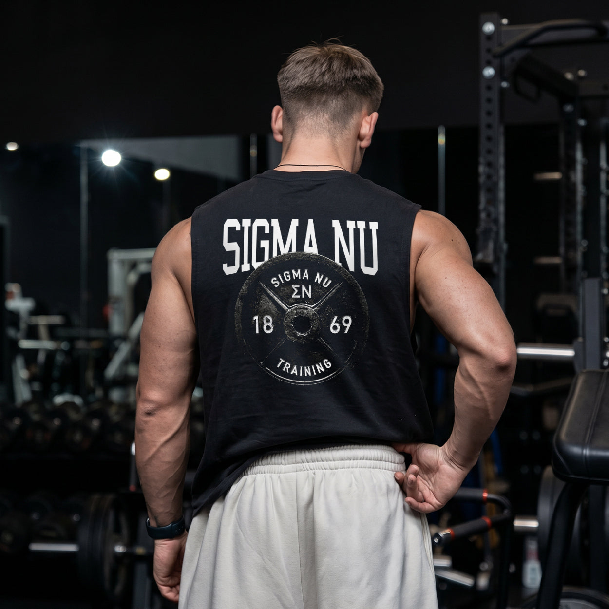 Man wearing a black cut off tank with premium grunge gym design