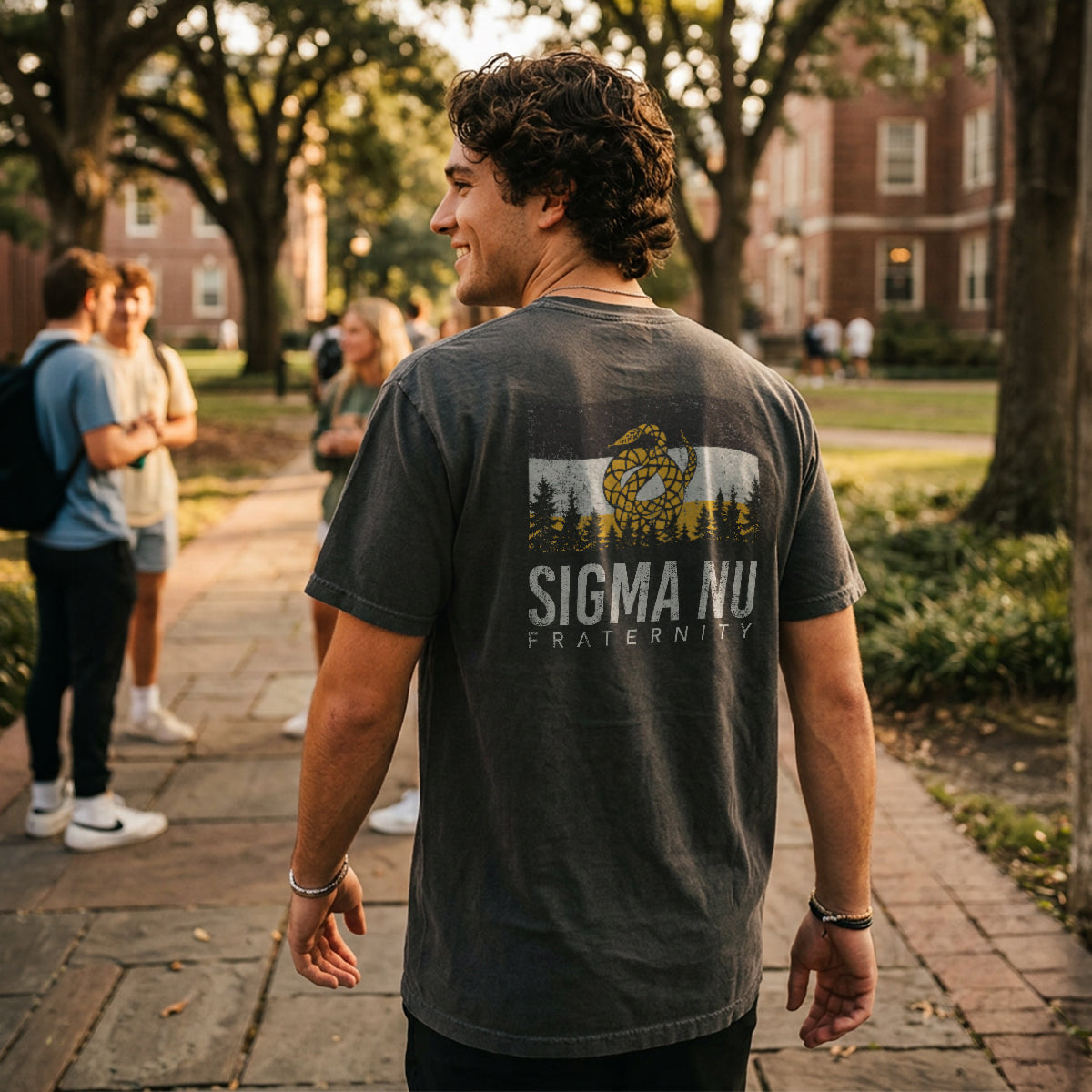 College student wearing fraternity grey t-shirt with colorful flag design on back