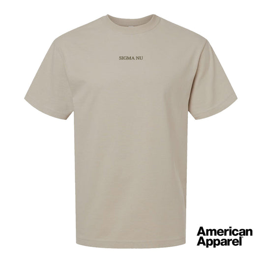 Beige short sleeve crewneck t-shirt with small embroidered text at the center chest on a clean background.